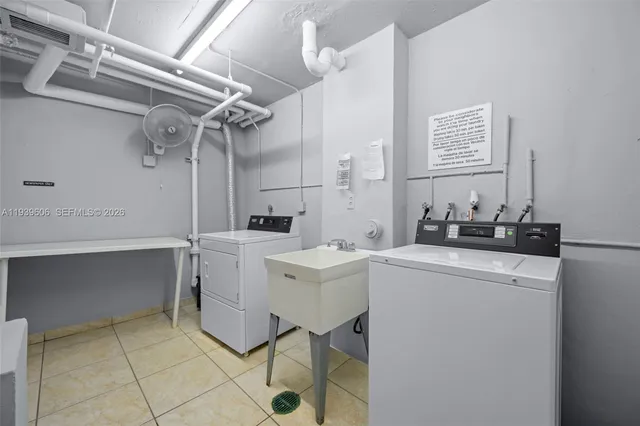 a utility room with cabinets washer and dryer