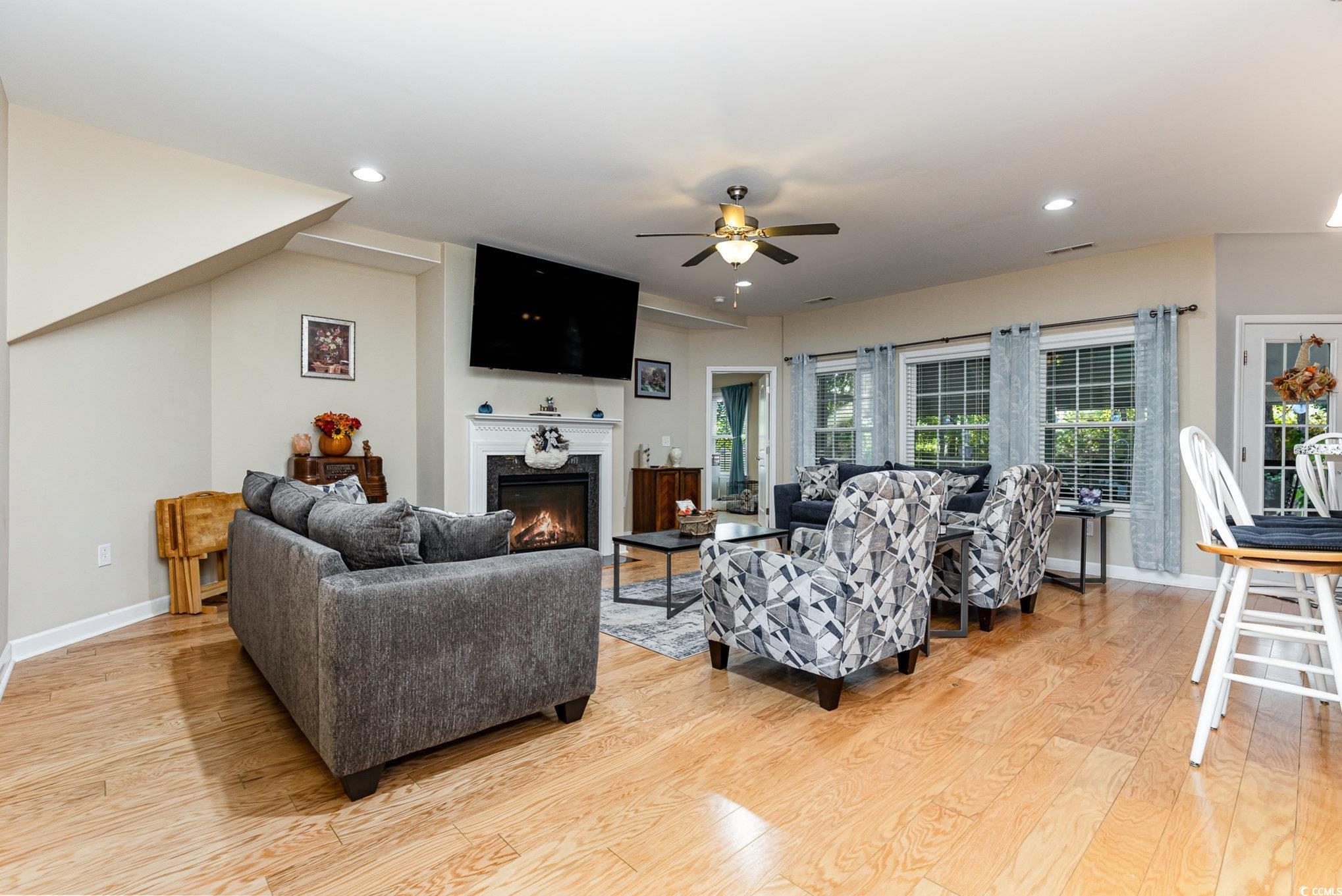 281 Marsh Tacky Loop Myrtle Beach, SC 29588 - Photo 12 of 39 Living room with a premium fireplace, light hardwo