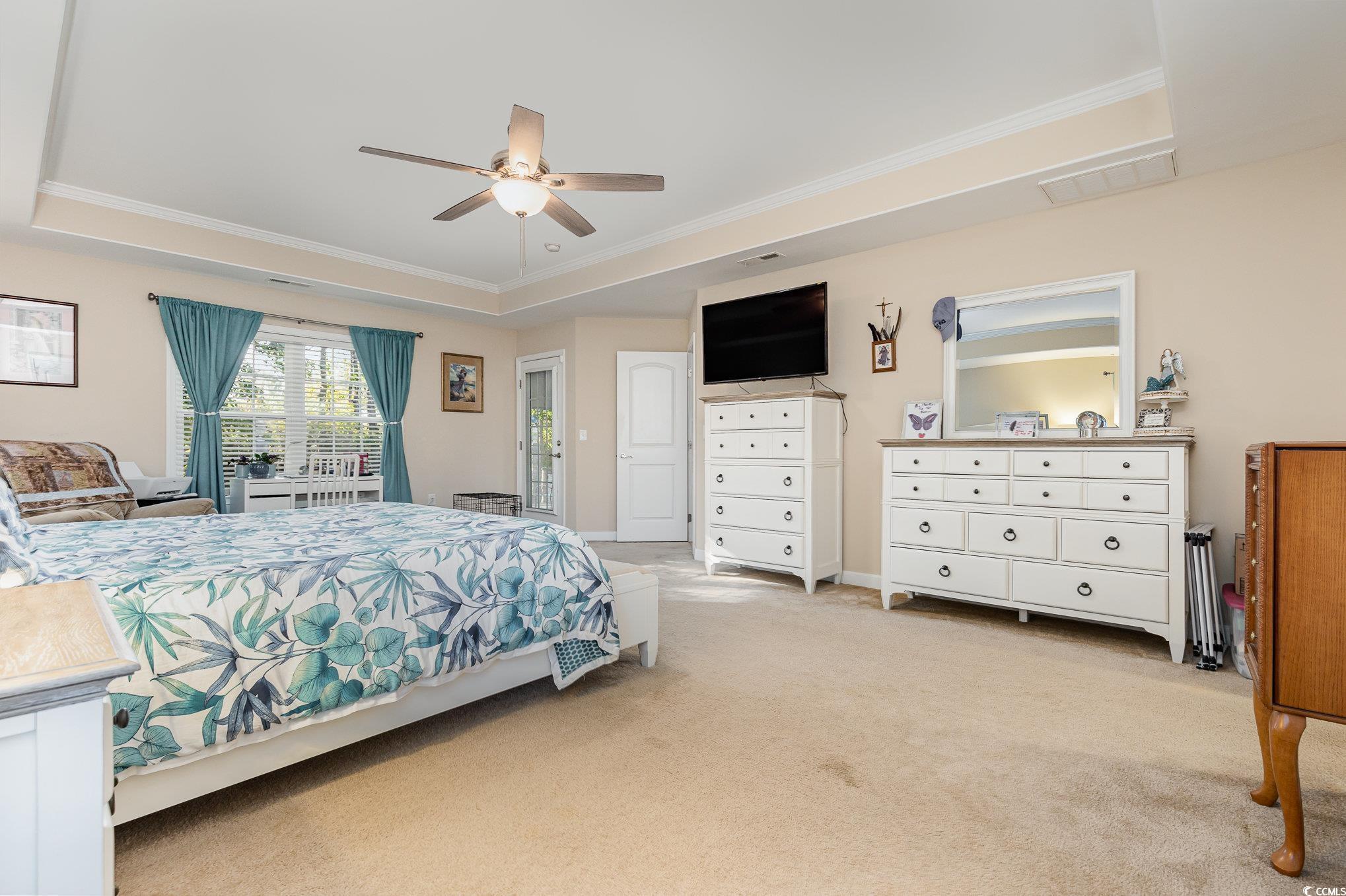 281 Marsh Tacky Loop Myrtle Beach, SC 29588 - Photo 15 of 39 Carpeted bedroom with ornamental molding, a tray c