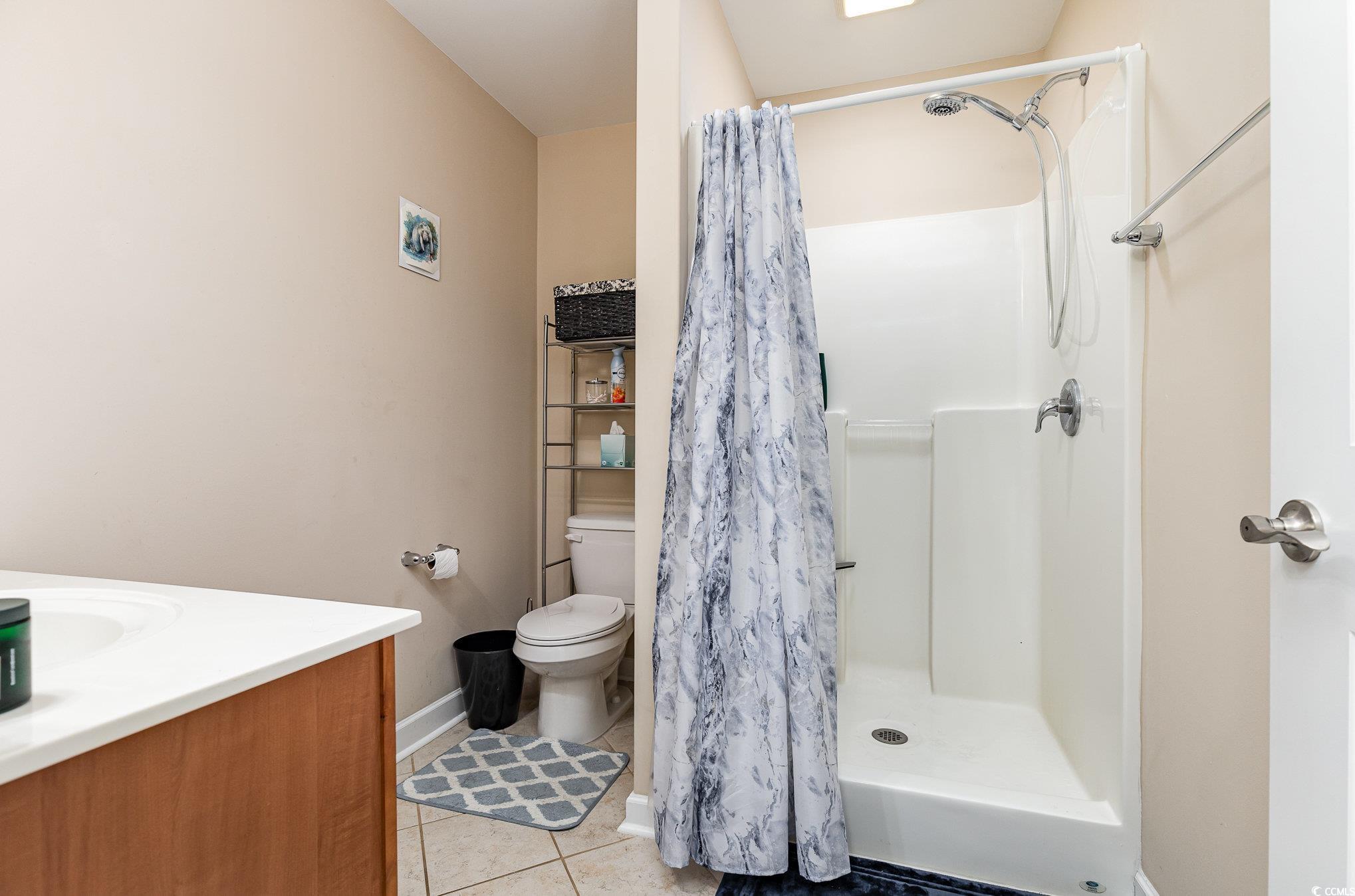 281 Marsh Tacky Loop Myrtle Beach, SC 29588 - Photo 22 of 39 Bathroom with vanity, toilet, tile patterned floor
