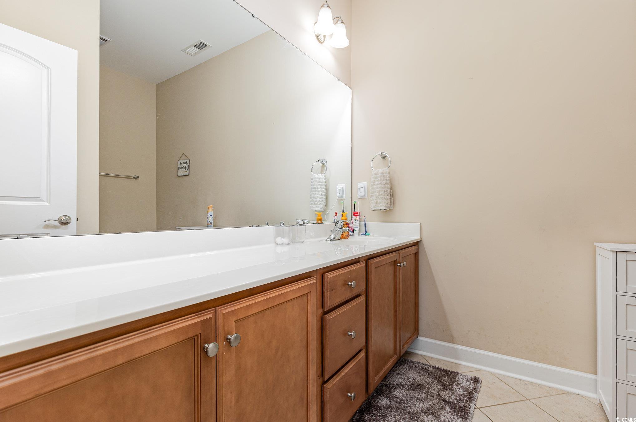 281 Marsh Tacky Loop Myrtle Beach, SC 29588 - Photo 23 of 39 Bathroom featuring vanity and tile patterned floor