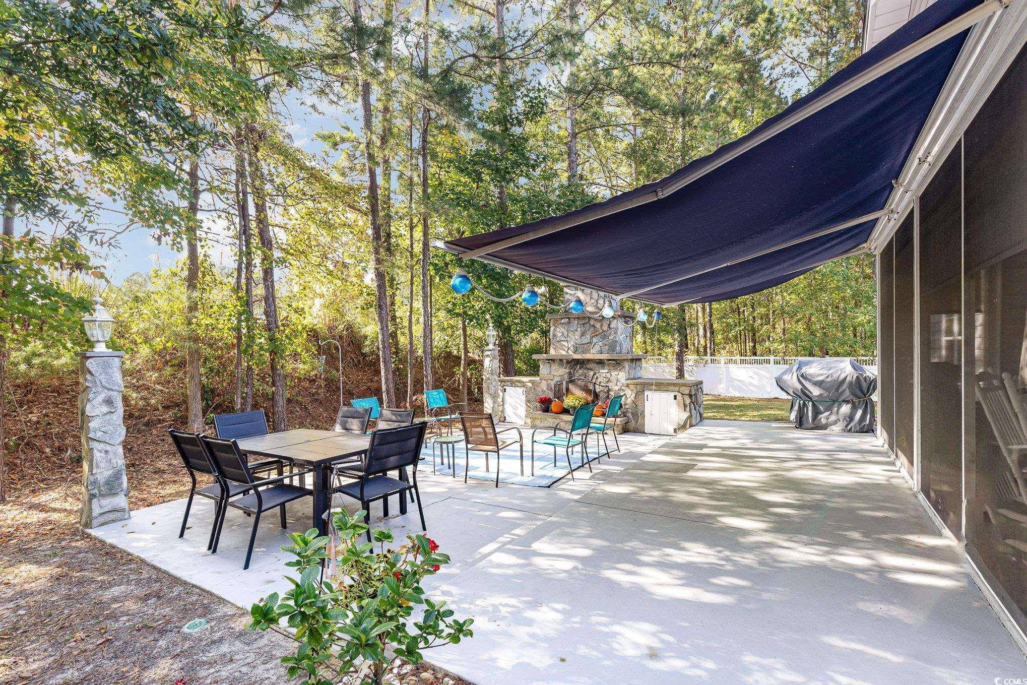 281 Marsh Tacky Loop Myrtle Beach, SC 29588 - Photo 26 of 39 View of patio with an outdoor stone fireplace and