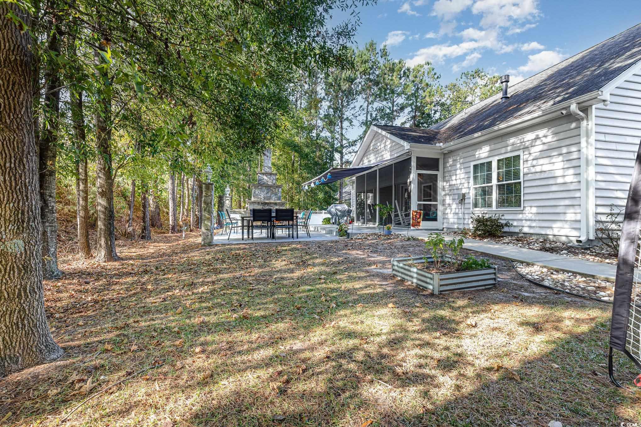 281 Marsh Tacky Loop Myrtle Beach, SC 29588 - Photo 31 of 39 View of yard featuring a patio and a sunroom