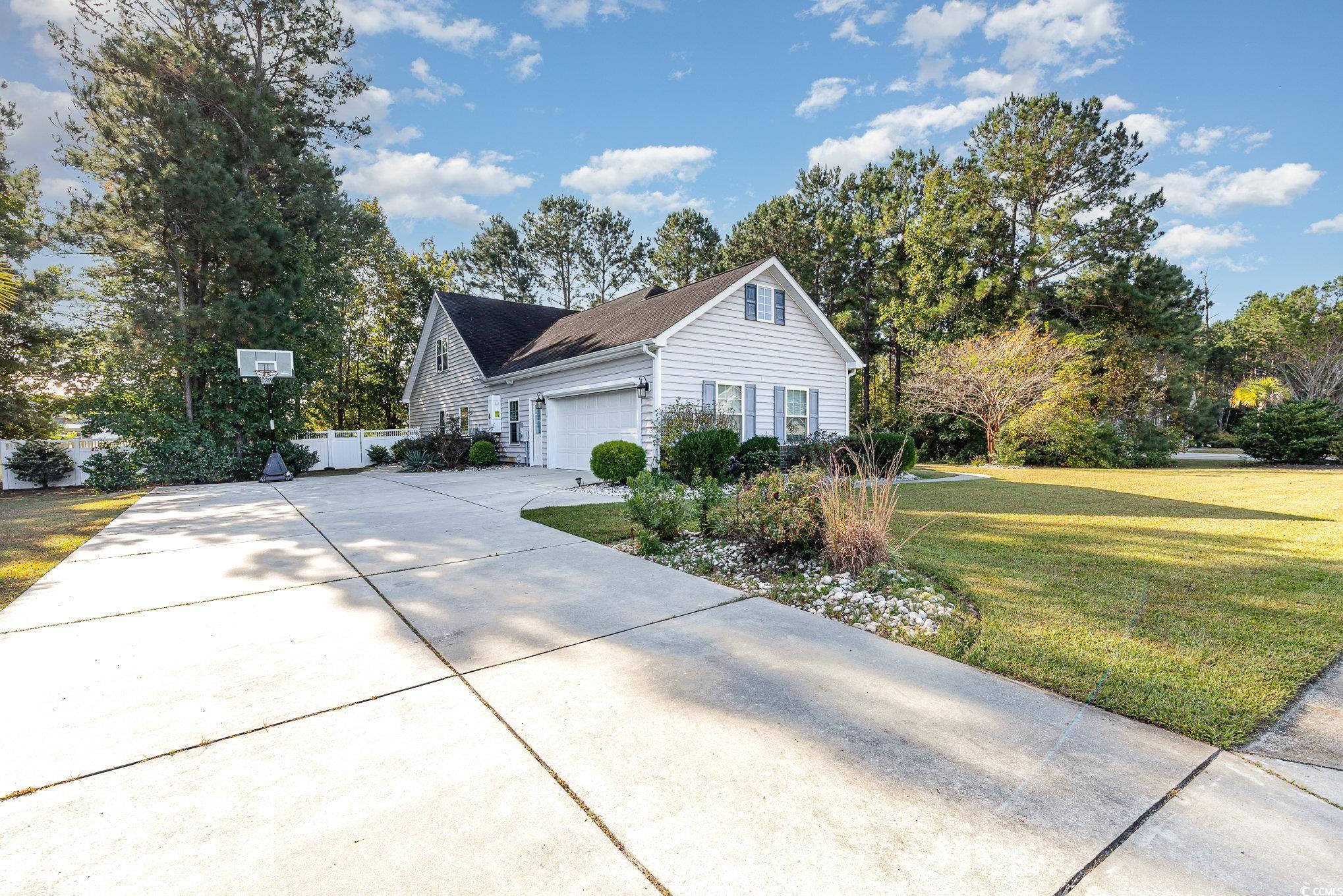 281 Marsh Tacky Loop Myrtle Beach, SC 29588 - Photo 34 of 39 View of side of home with a yard and a garage