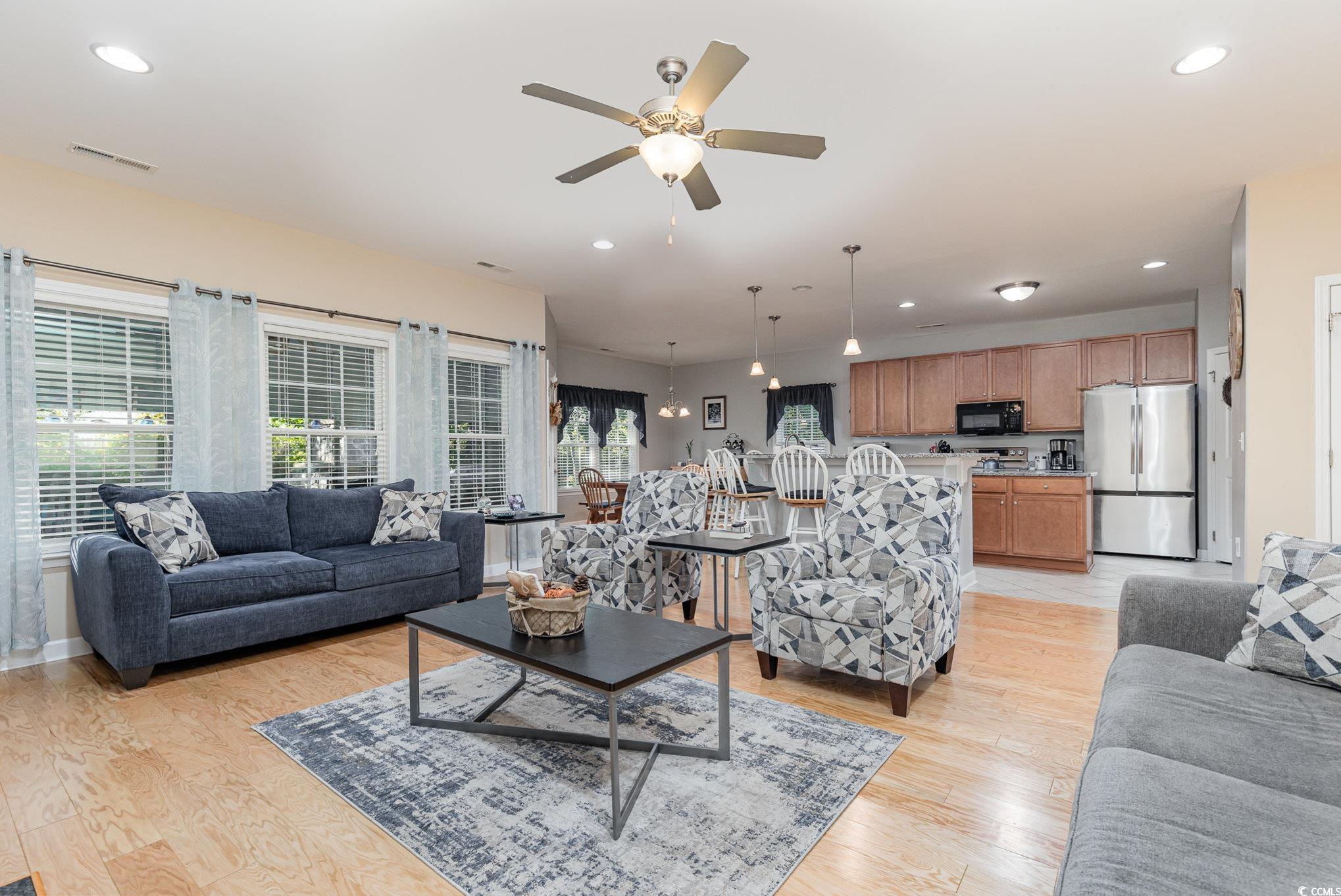 281 Marsh Tacky Loop Myrtle Beach, SC 29588 - Photo 10 of 39 Living room featuring ceiling fan and light hardwo