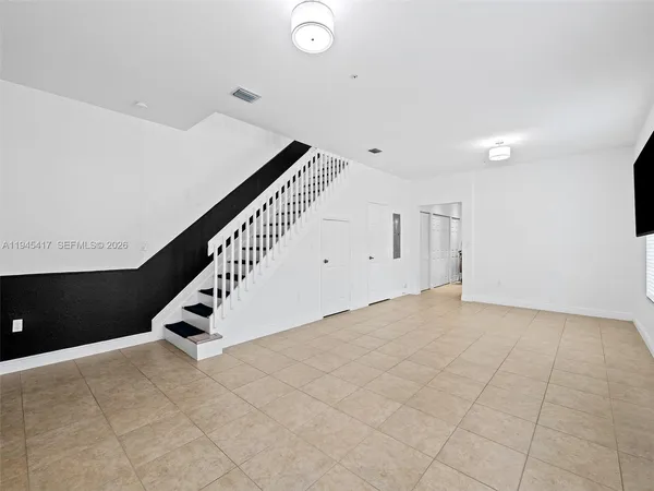 a view of an empty room with stairs
