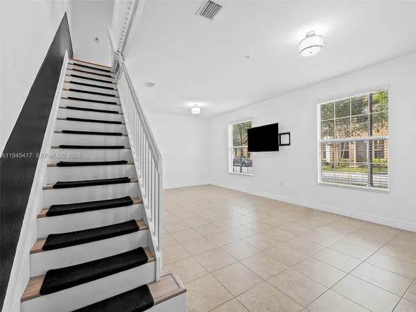 a view of a livingroom with wooden floor and windows