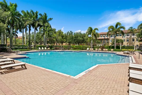 a view of a swimming pool and trees in the background
