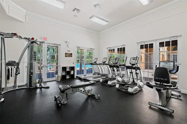 a room with gym equipment and a large window