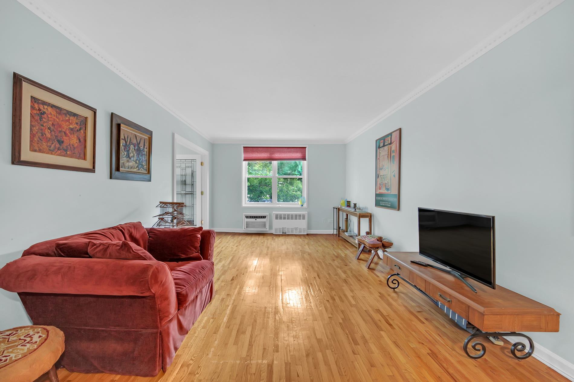 9411 Shore Road, Unit 1O Brooklyn, NY 11209 - Photo 12 of 19 a living room with furniture and a flat screen tv