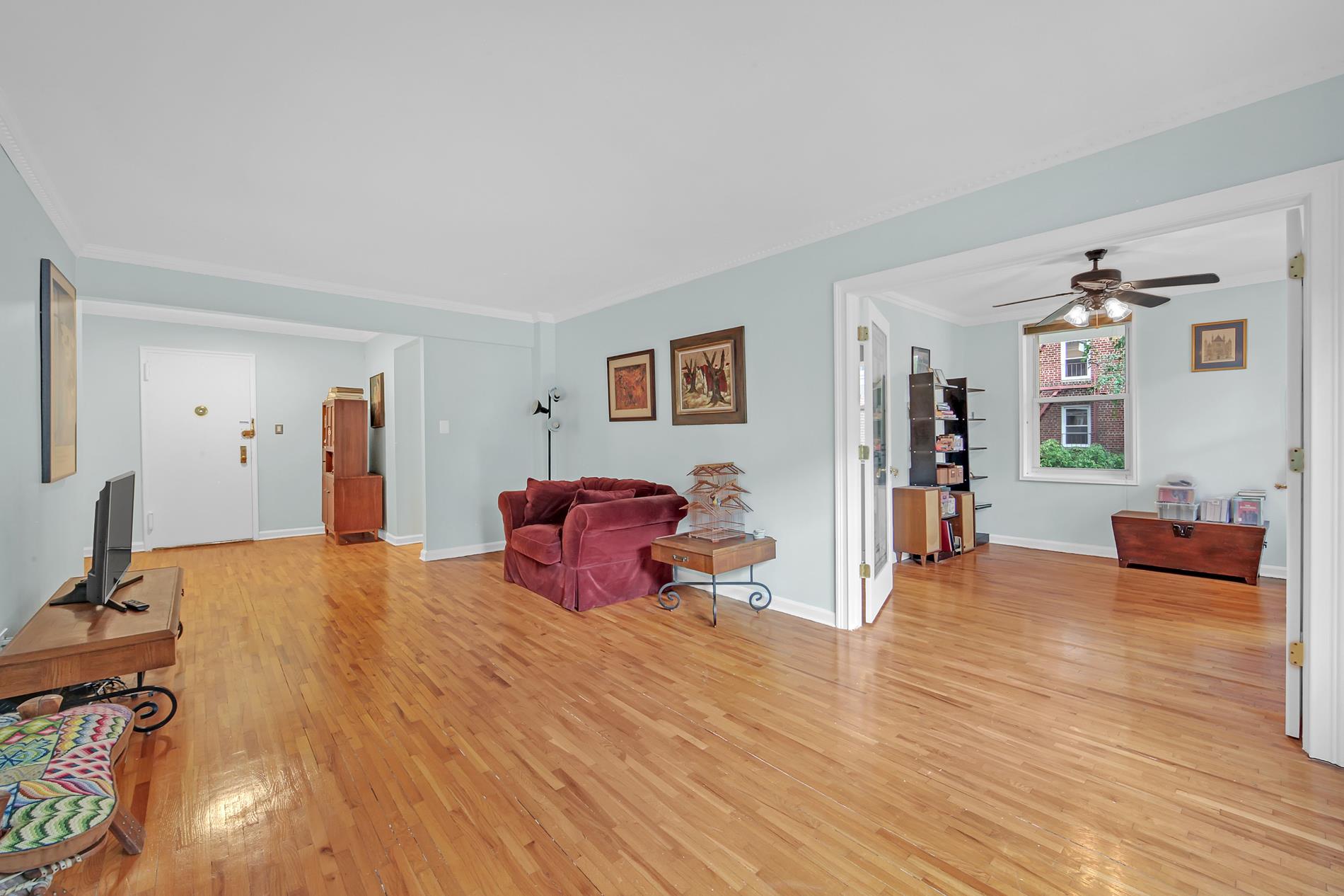 9411 Shore Road, Unit 1O Brooklyn, NY 11209 - Photo 13 of 18 a bed room with furniture and a wooden floor