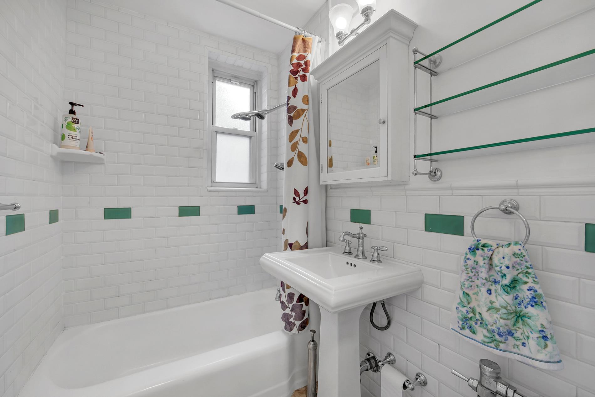9411 Shore Road, Unit 1O Brooklyn, NY 11209 - Photo 18 of 19 a bathroom with a sink and a mirror