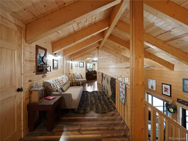 a view of a patio with couches chairs and wooden floor