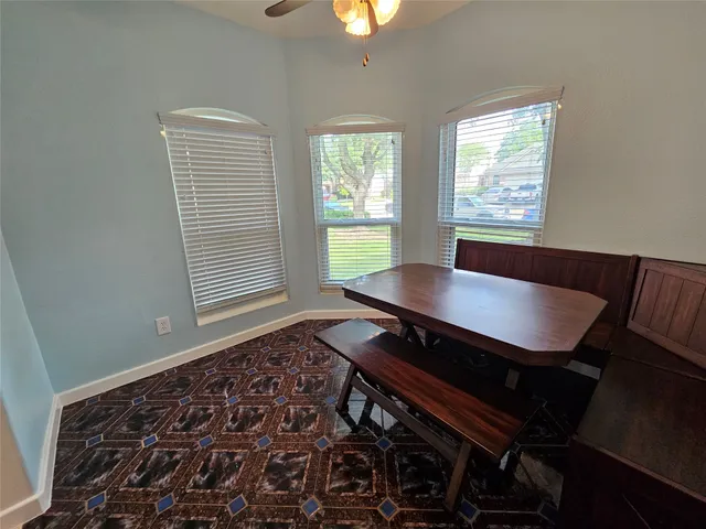 a black leather chair sitting in a bedroom next to a window