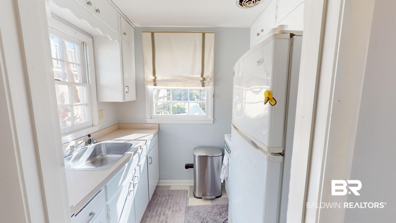 4358 Stein Street Mobile, AL 36608 - Photo 23 of 29 Kitchen featuring white cabinetry, white fridge, and a healthy amount of sunlight