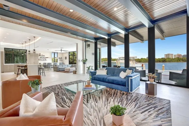 a living room with furniture and large windows