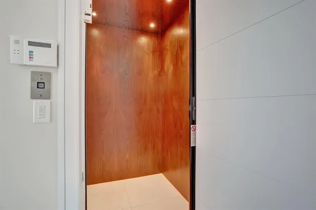 a bathroom with a toilet sink vanity and mirror