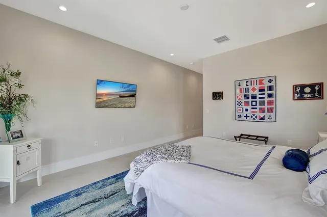 a living room with furniture a ceiling fan and a flat screen tv