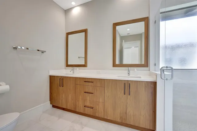 an aerial view of a house with a garden and lake view