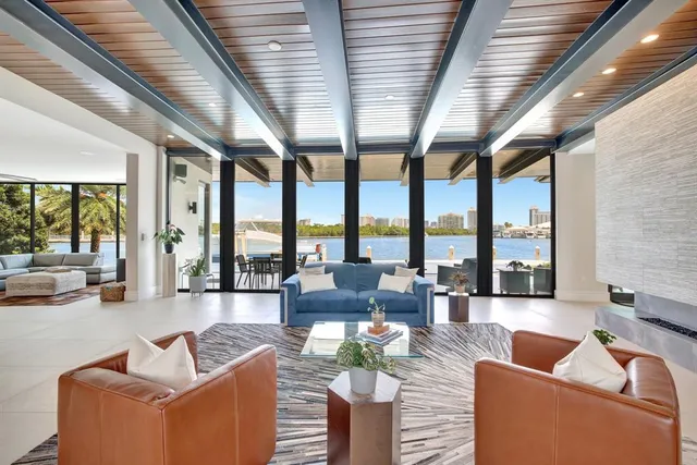 a living room with furniture and large windows