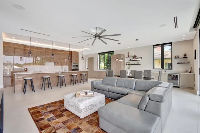 a room with stainless steel appliances kitchen island furniture and a large window