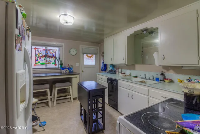 a kitchen that has a sink and a stove in it