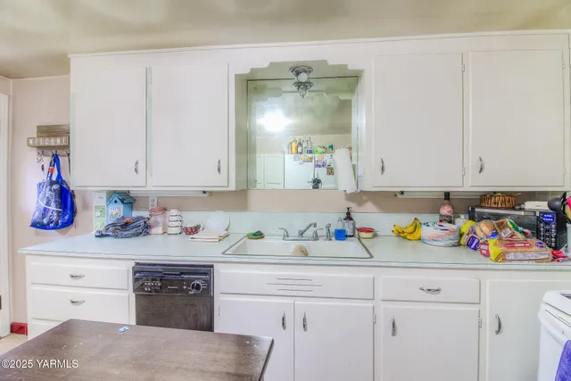 a kitchen with a sink a stove and cabinets