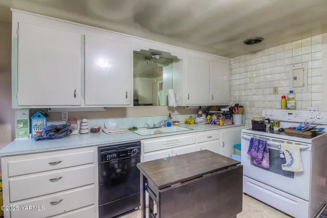 a kitchen with a stove a sink and cabinets
