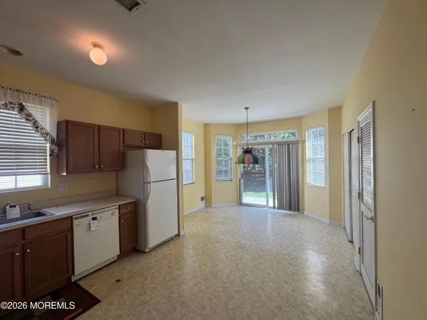 a kitchen with stainless steel appliances a refrigerator and a sink