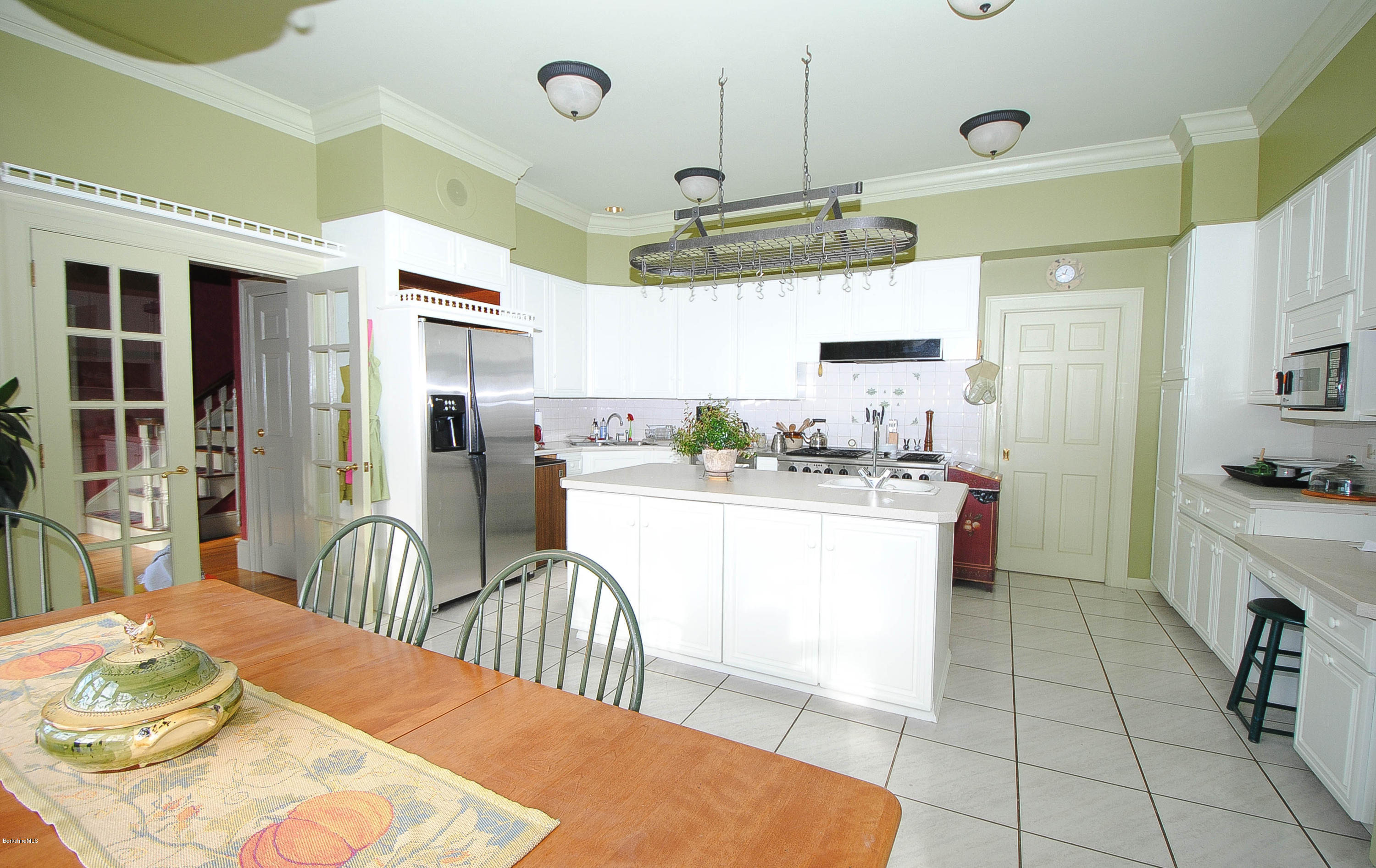 55 Maple Hill Road West Stockbridge, MA 01266 - Photo 33 of 63 a kitchen with stainless steel appliances granite countertop a refrigerator a oven a sink a dining table and chairs with wooden floor