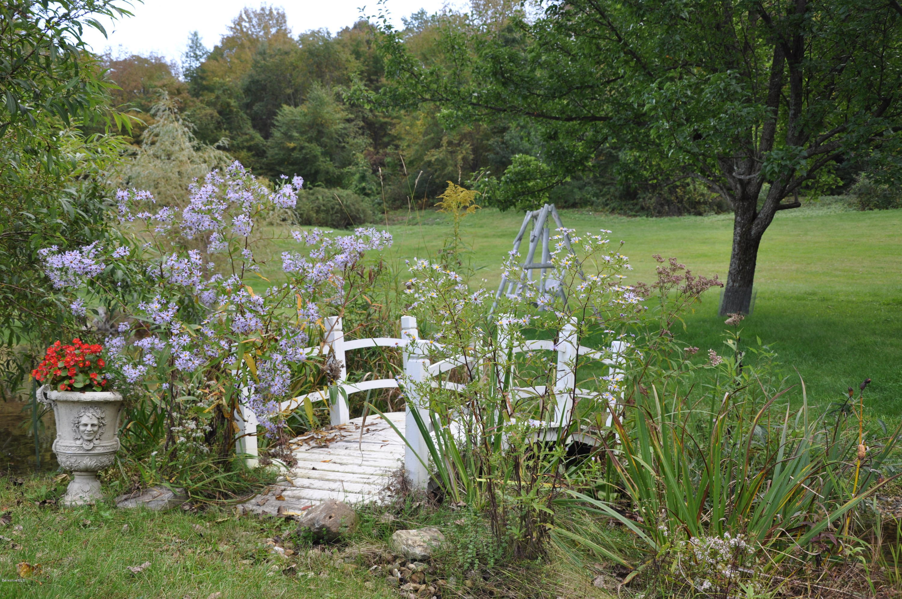 55 Maple Hill Road West Stockbridge, MA 01266 - Photo 51 of 63 a backyard of a house with yard and outdoor seating