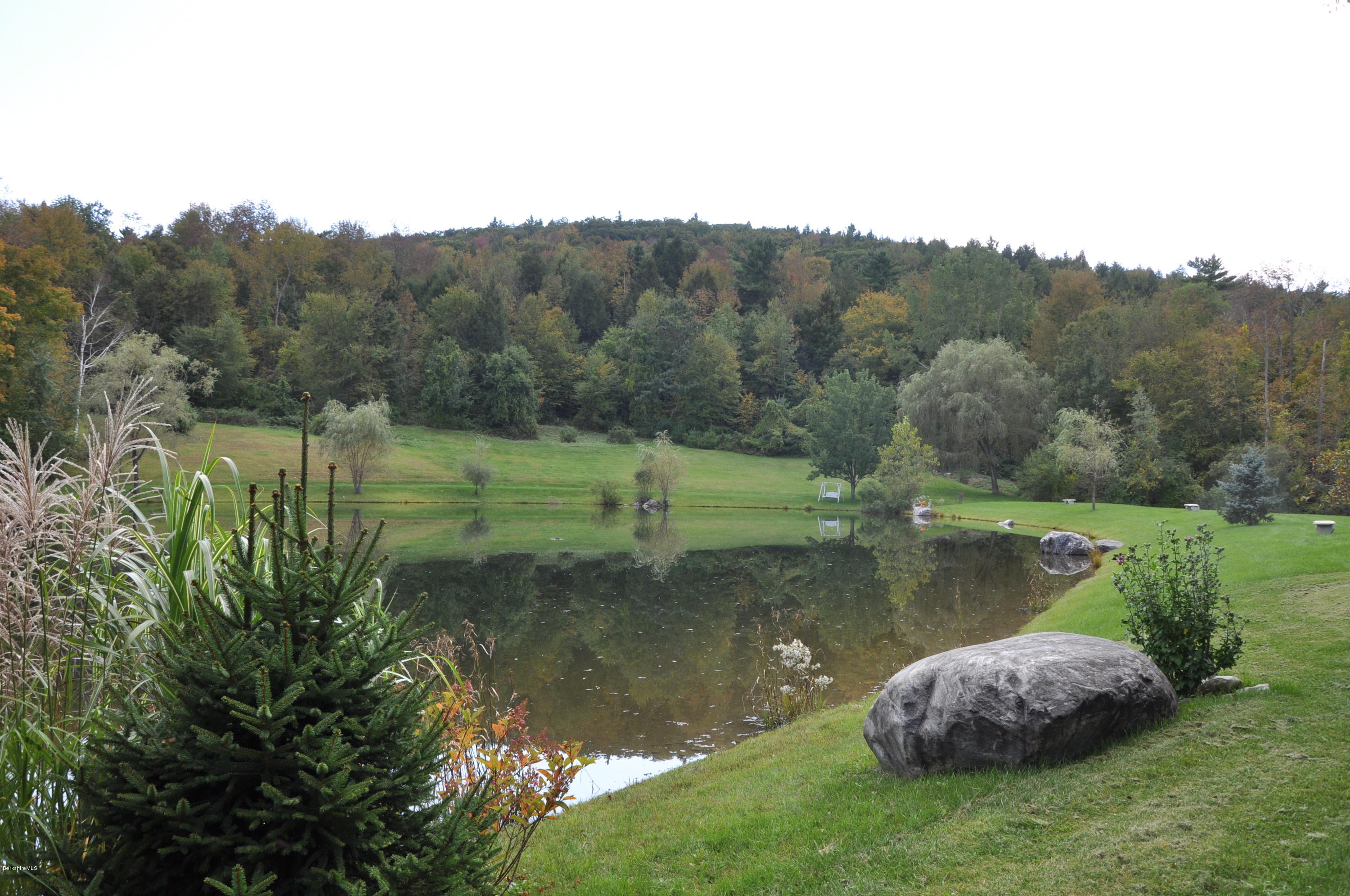 55 Maple Hill Road West Stockbridge, MA 01266 - Photo 52 of 63 a view of a lake with a mountain in the background