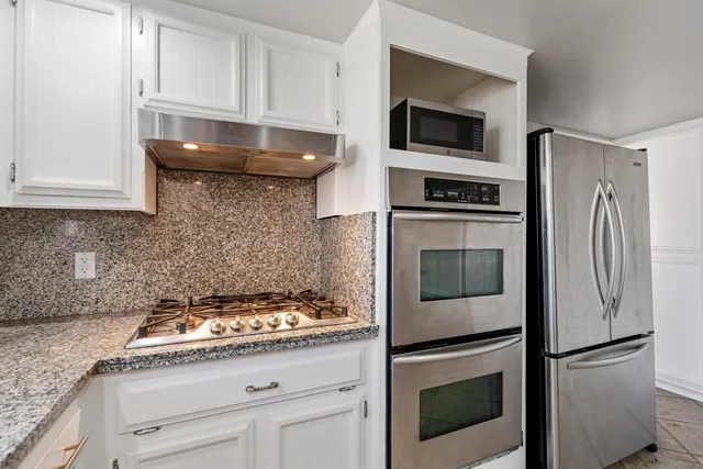 a kitchen with a stove and a refrigerator