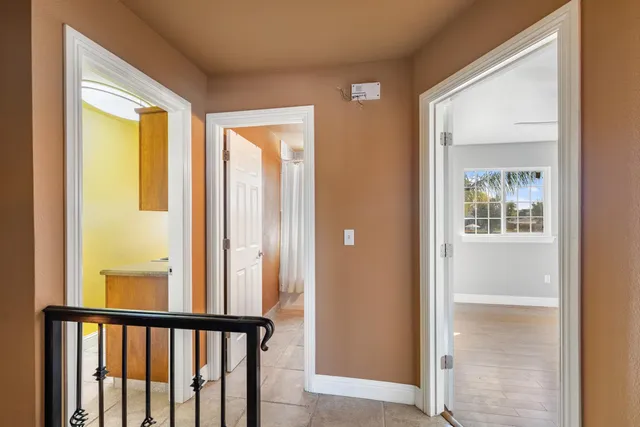 a bathroom with a granite countertop sink toilet mirror and bathtub