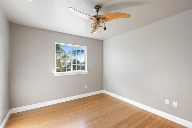 a view of a kitchen with a sink and a refrigerator