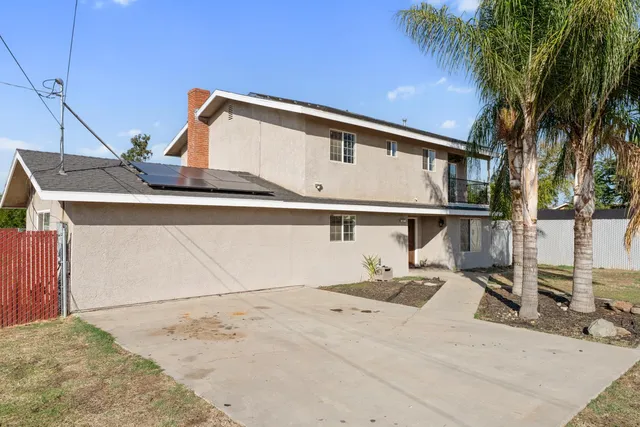 a view of a house with a wooden fence