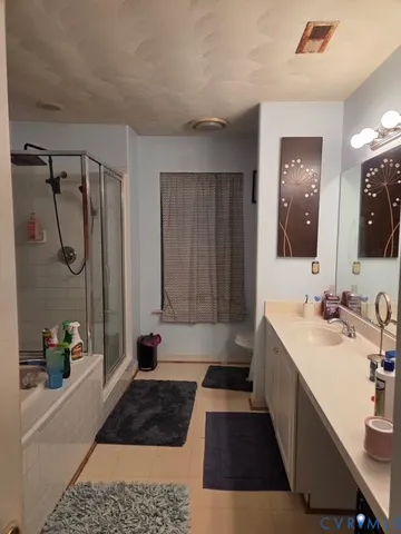 a bathroom with a sink a toilet a mirror a vanity and shower