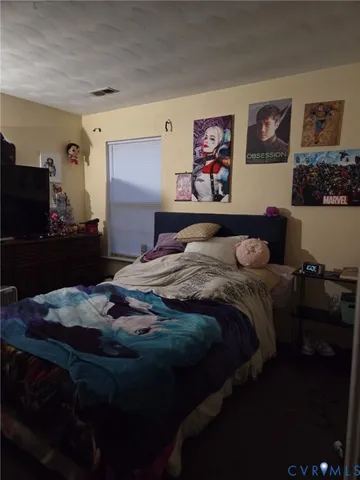 a bedroom with a bed and a black cabinet