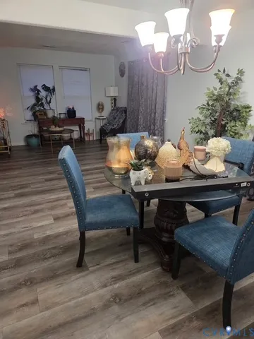 a dining room with furniture and wooden floor