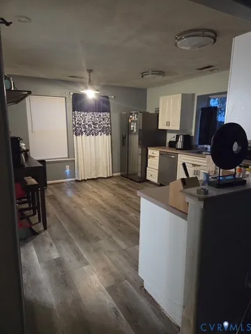 a open kitchen with sink cabinets and a refrigerator