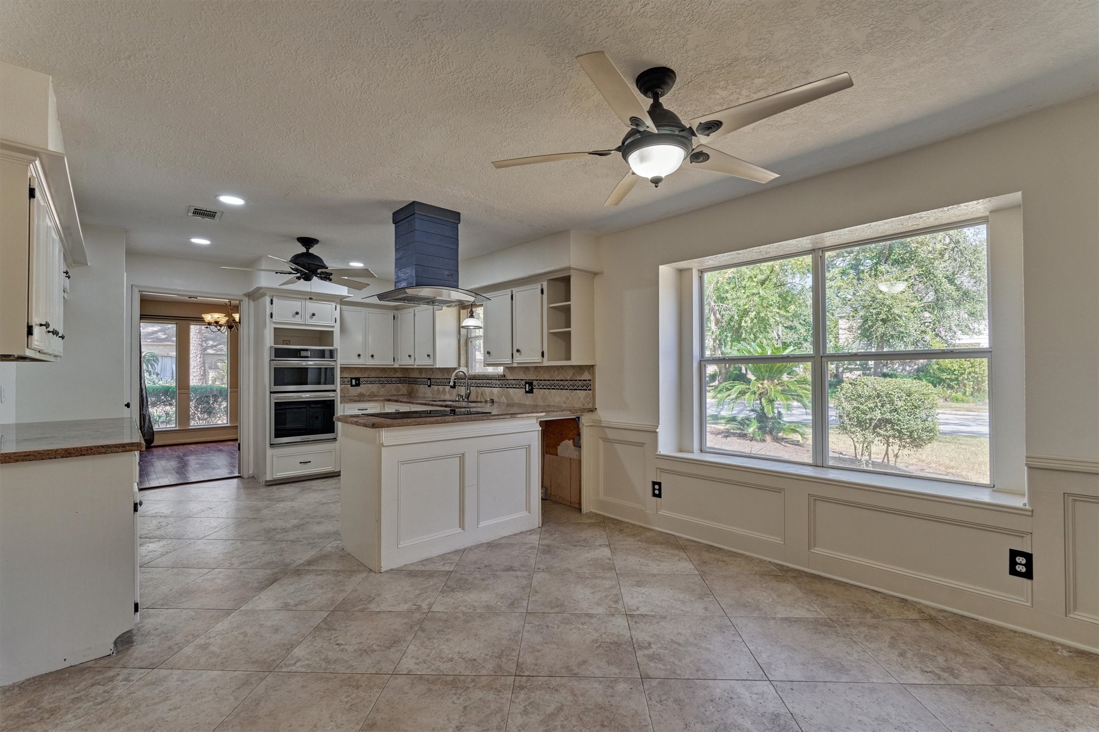 5503 Alamosa Lane Spring, TX 77379 - Photo 14 of 38 a kitchen with kitchen island granite countertop a stove and a sink with granite countertops