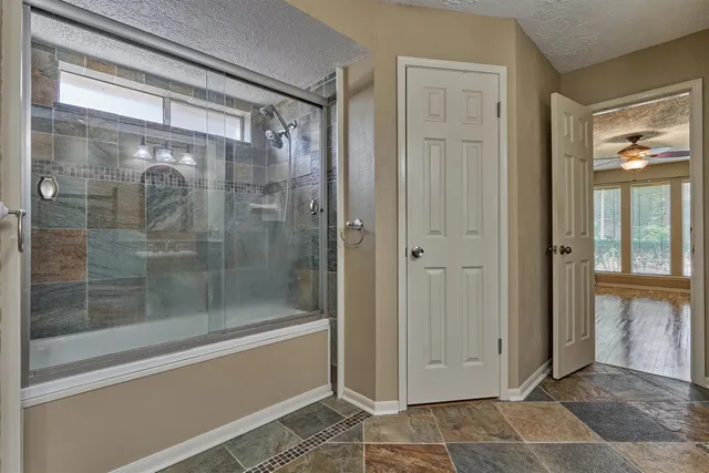 a bathroom with a glass shower door