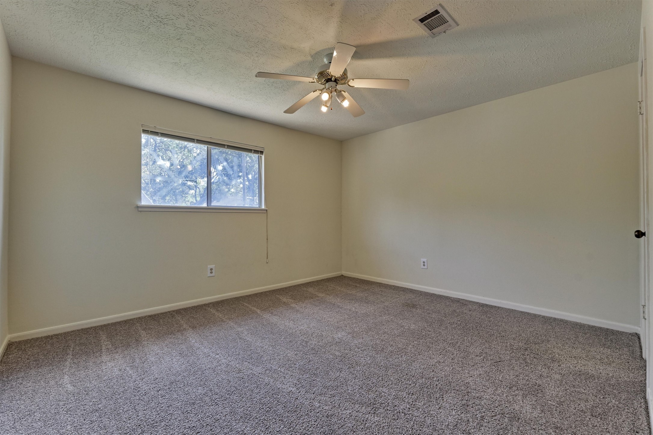 5503 Alamosa Lane Spring, TX 77379 - Photo 30 of 38 an empty room with a ceiling fan and window
