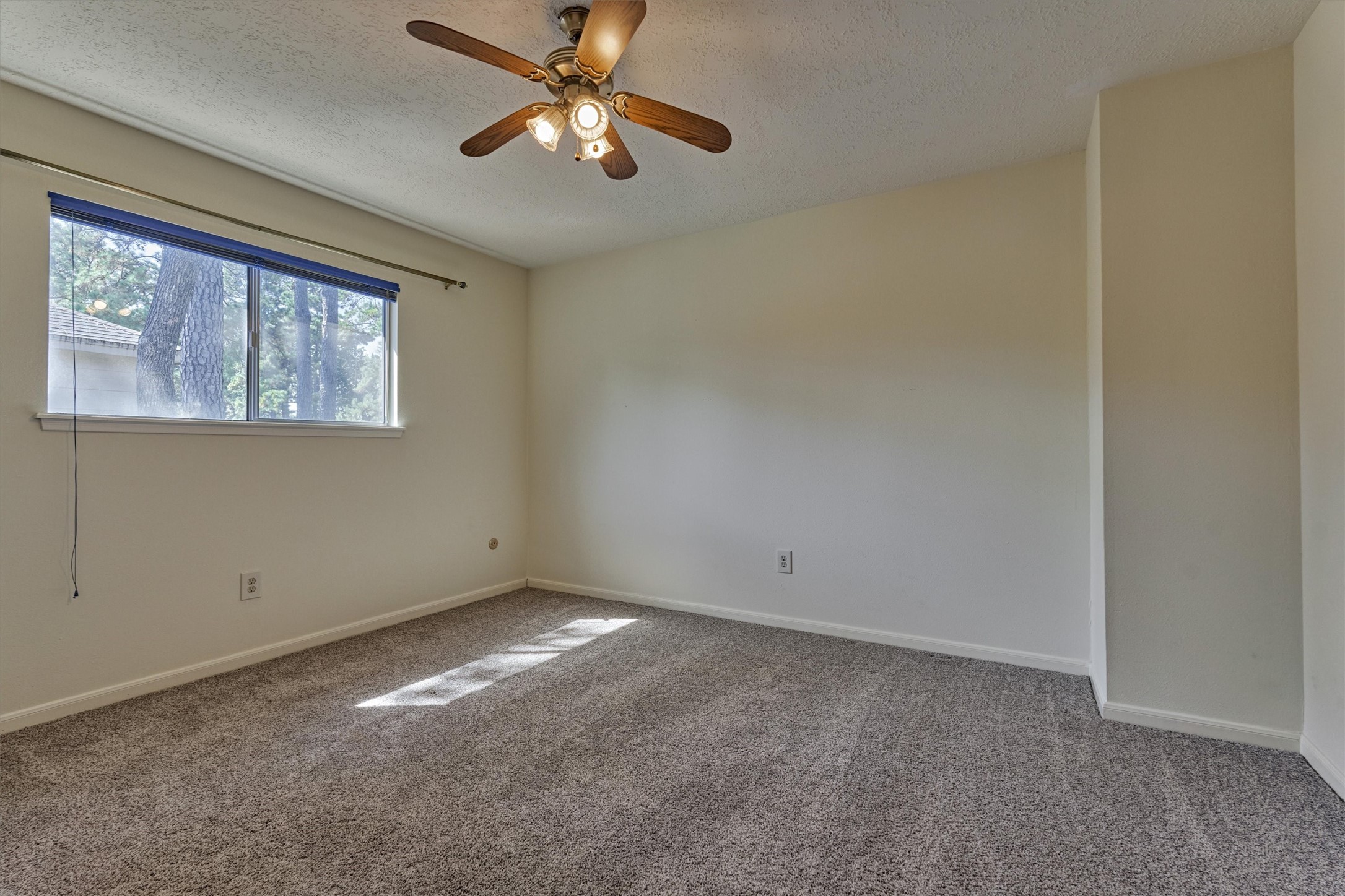 5503 Alamosa Lane Spring, TX 77379 - Photo 32 of 38 an empty room with a window and a fan