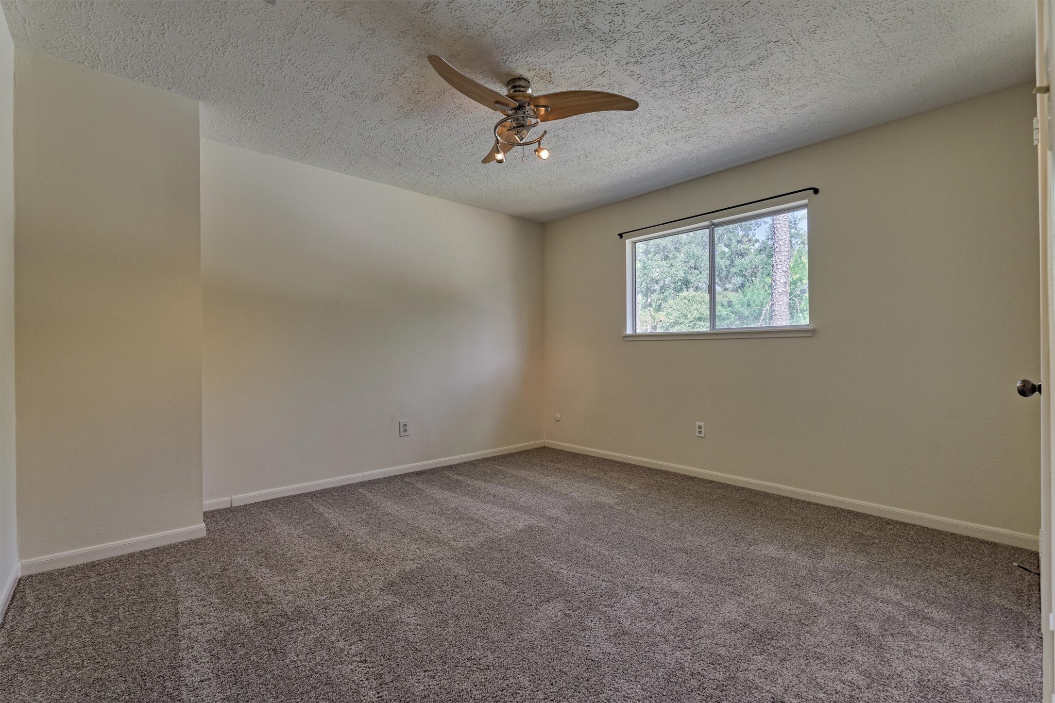 5503 Alamosa Lane Spring, TX 77379 - Photo 34 of 38 an empty room with a ceiling fan and window