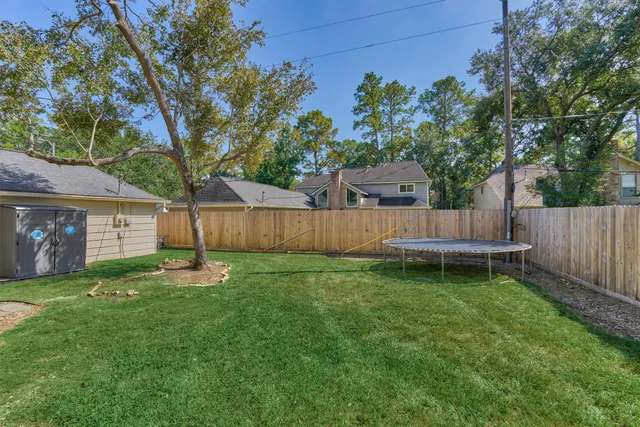 a view of a house with a yard and sitting area