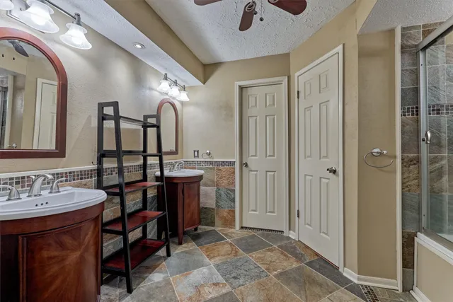 a spacious bathroom with a double vanity sink and a mirror