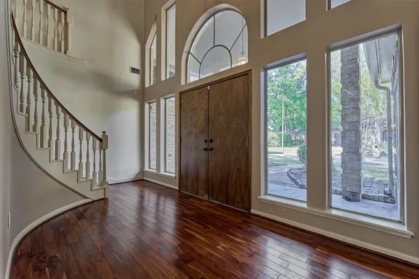 a view of an entryway with wooden floor and door