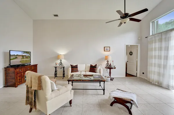 a living room with furniture and a ceiling fan