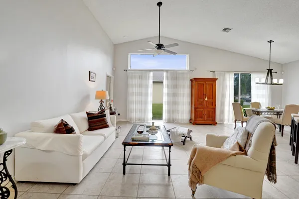 a living room with furniture a chandelier and a chandelier